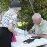 An older man and woman sitting at a table.